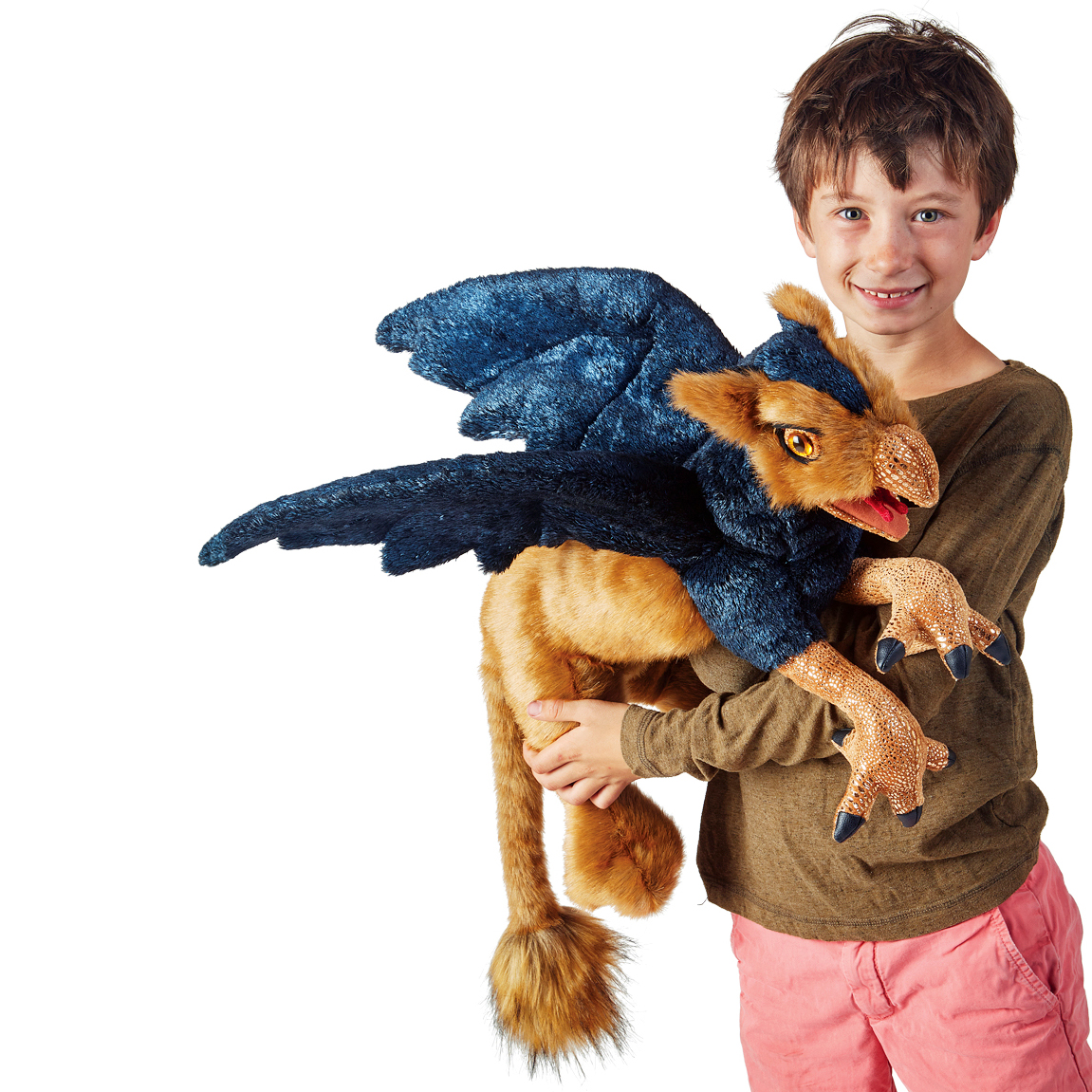 Boy holding a large Folkmanis griffin hand puppet with dark blue plumage, golden lion body and open beak against a white background