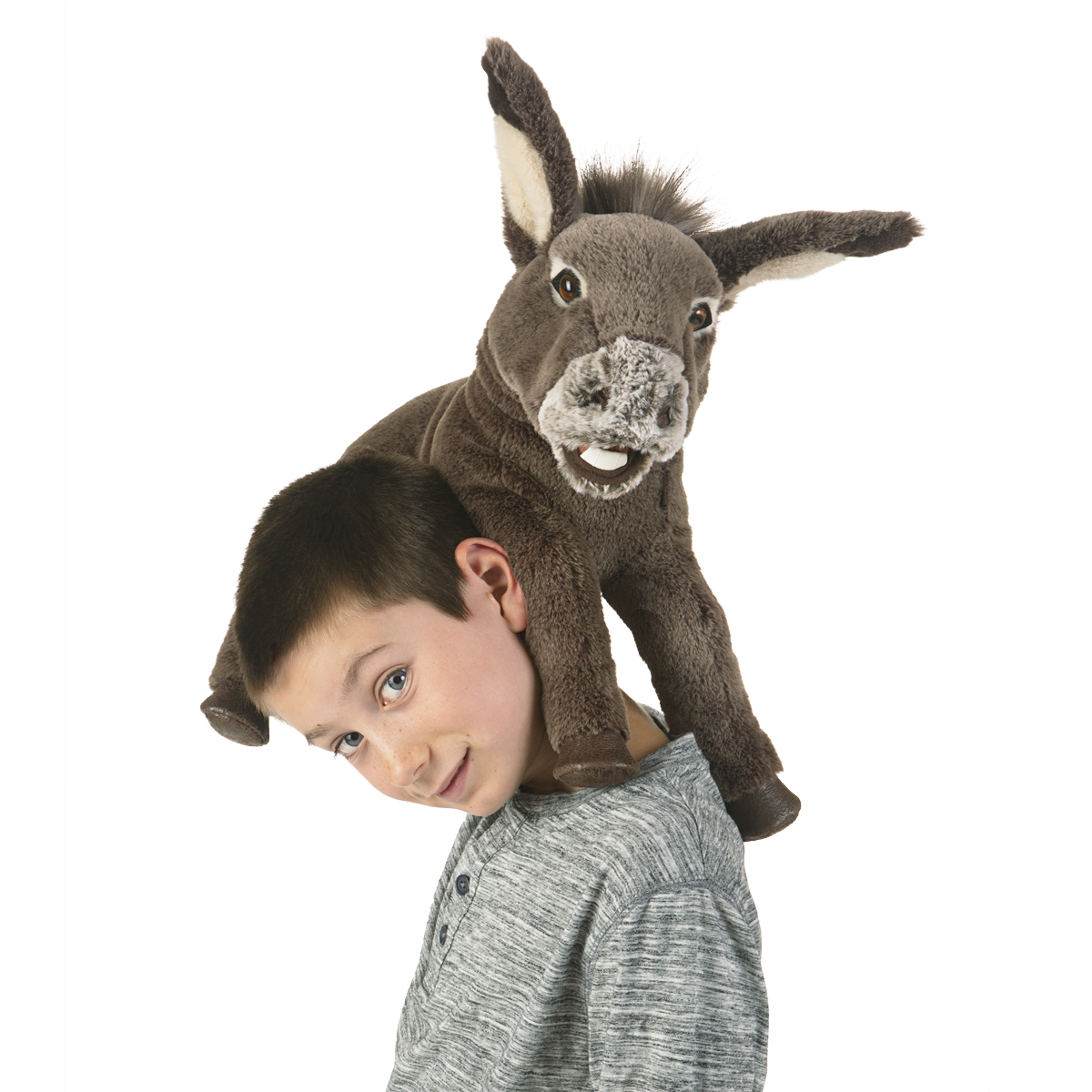 Folkmanis baby donkey hand puppet in grey-brown on the shoulder of a smiling boy, with movable mouth and long ears