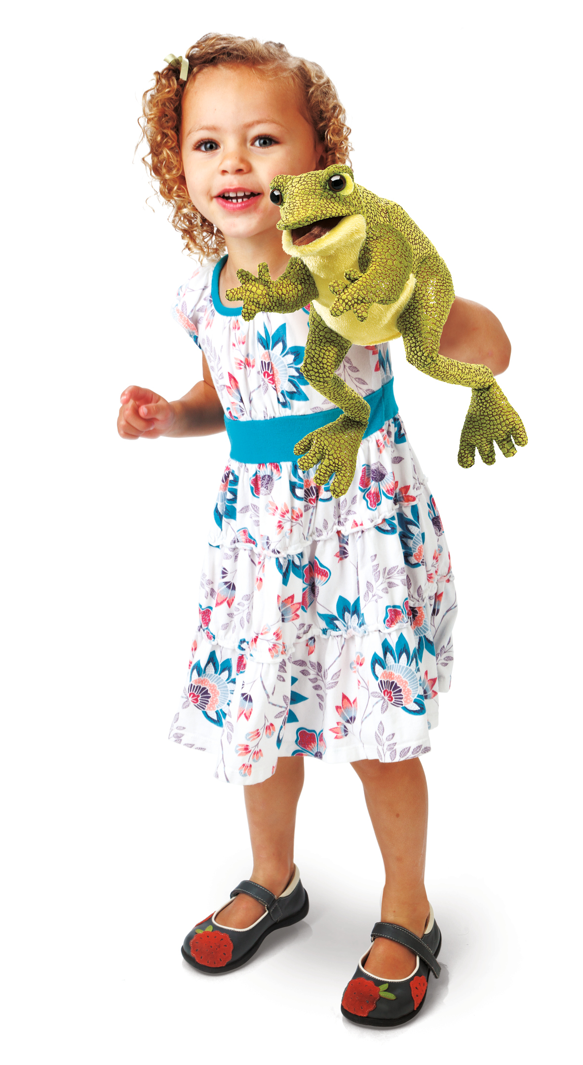 Smiling little girl holding up the Folkmanis Funny Frog hand puppet with its mouth open