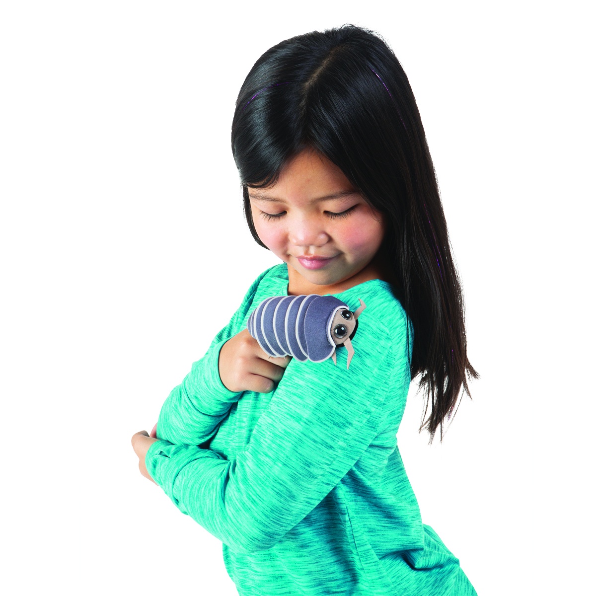 Girl holding a Folkmanis mini pill bug finger puppet with a blue-grey armoured body on her shoulder, smiling at it