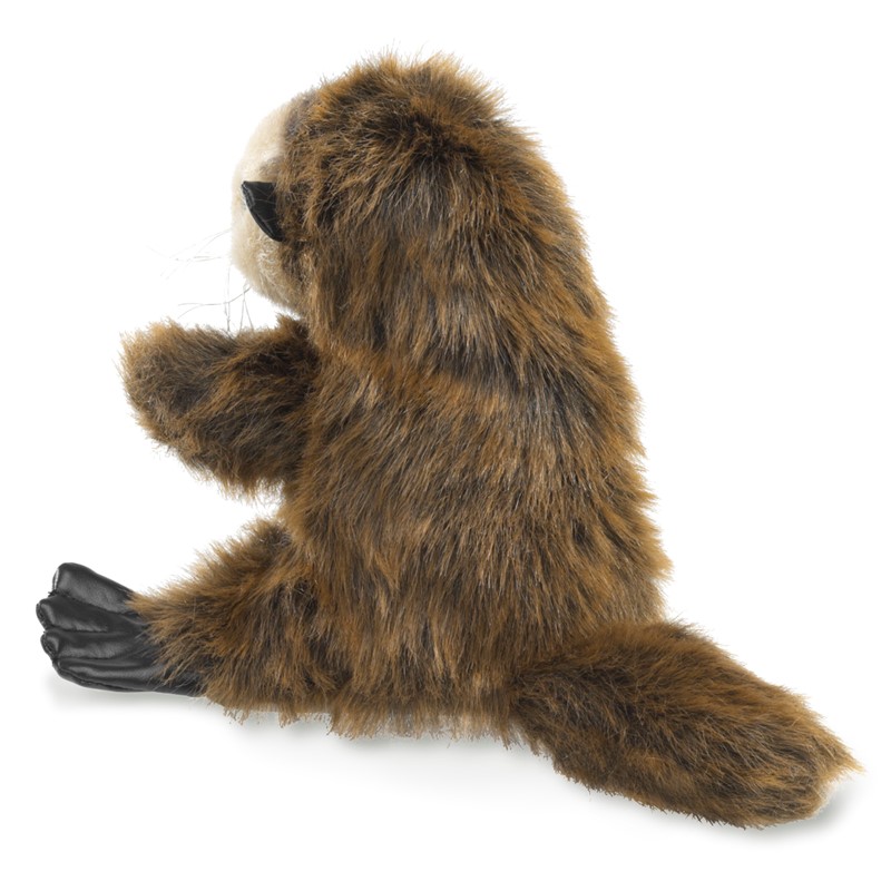 Folkmanis baby sea otter hand puppet in side view, brown shaggy fur, black leather hind paws and a bushy tail