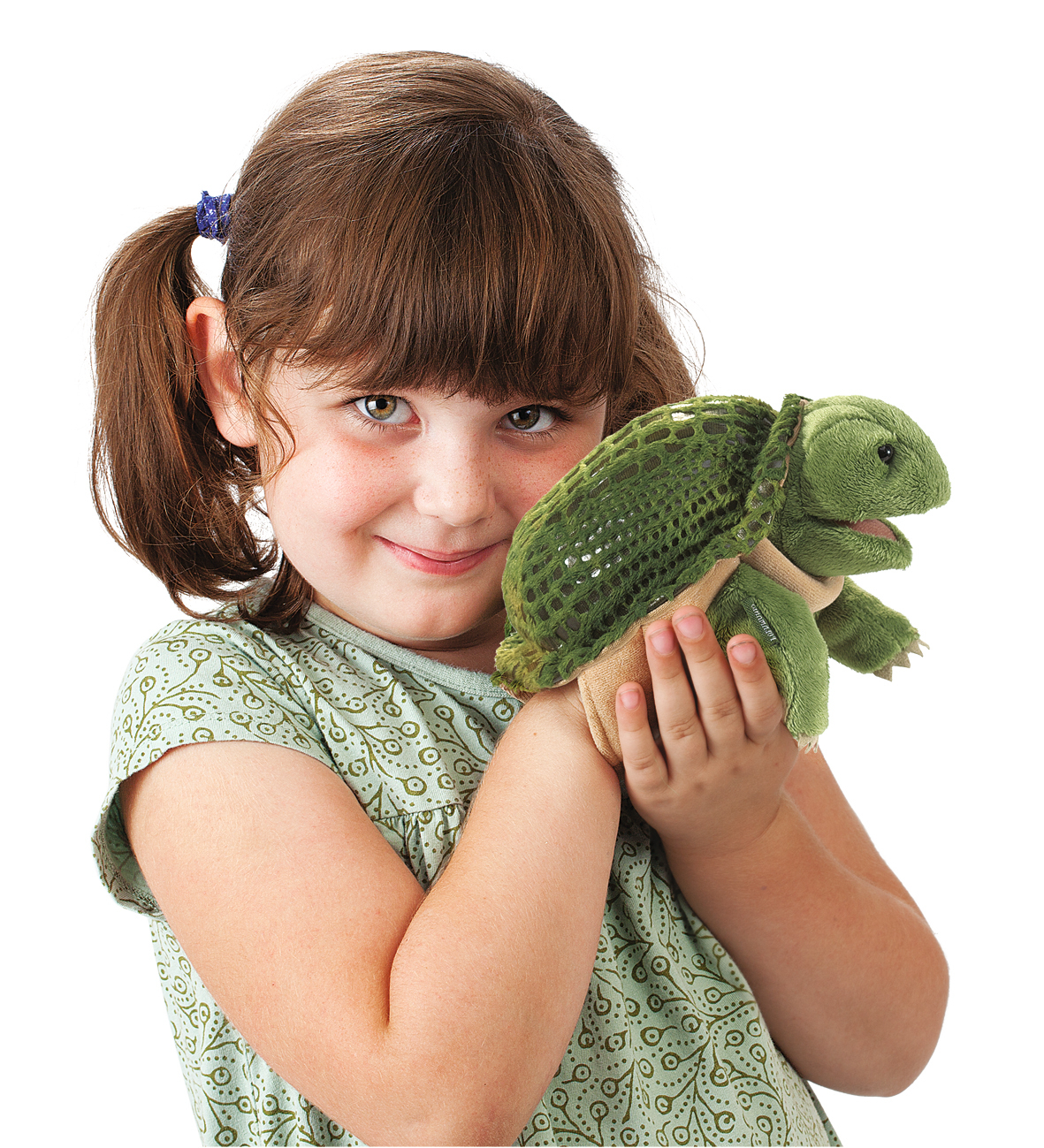 Girl holding the Folkmanis hand puppet little turtle with green shell and plush head in both hands
