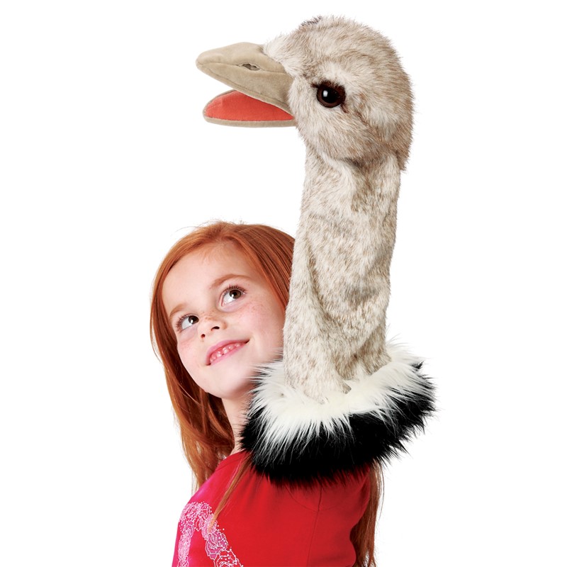 Folkmanis ostrich hand puppet with a long grey-speckled neck and open beak, held up high by a girl