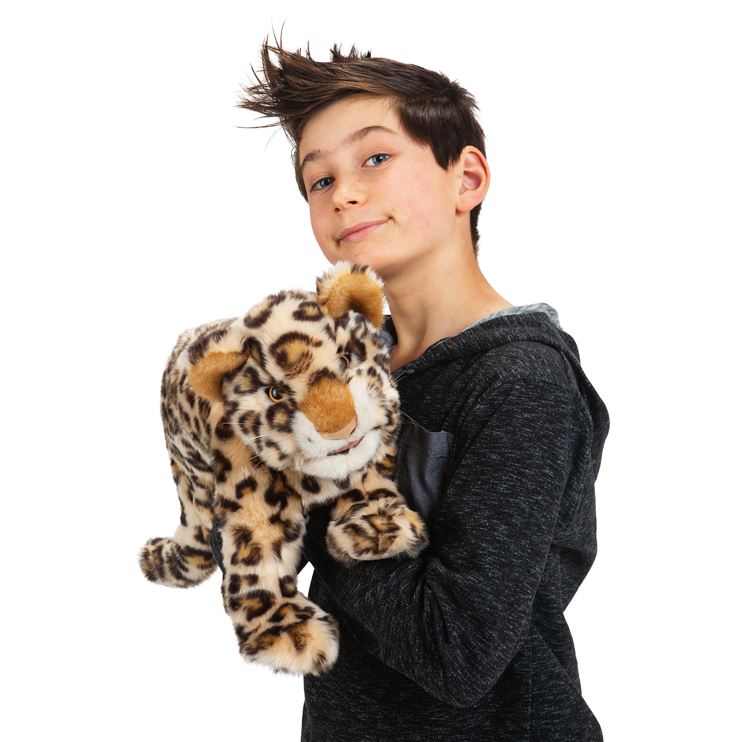 Boy holding a Folkmanis leopard cub hand puppet with beige fur and black spots, front view