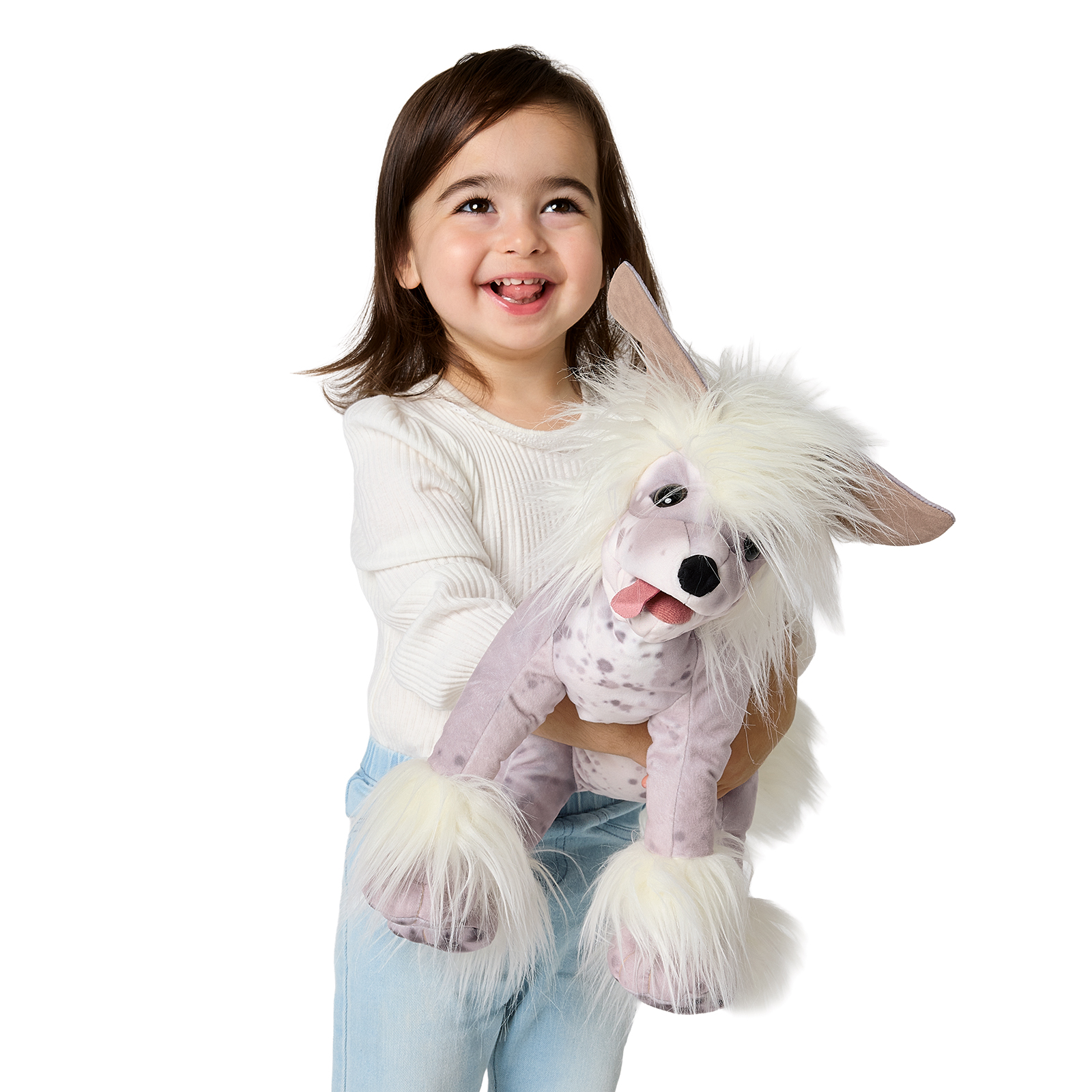Girl holding a Folkmanis Chinese Crested Dog hand puppet with a white crest, speckled coat and tongue sticking out