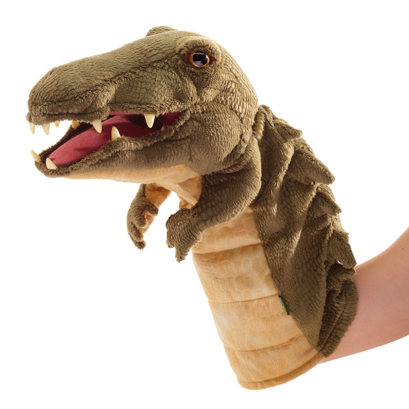 Folkmanis crocodile hand puppet with open mouth, visible teeth and olive-green plush texture, worn on hand