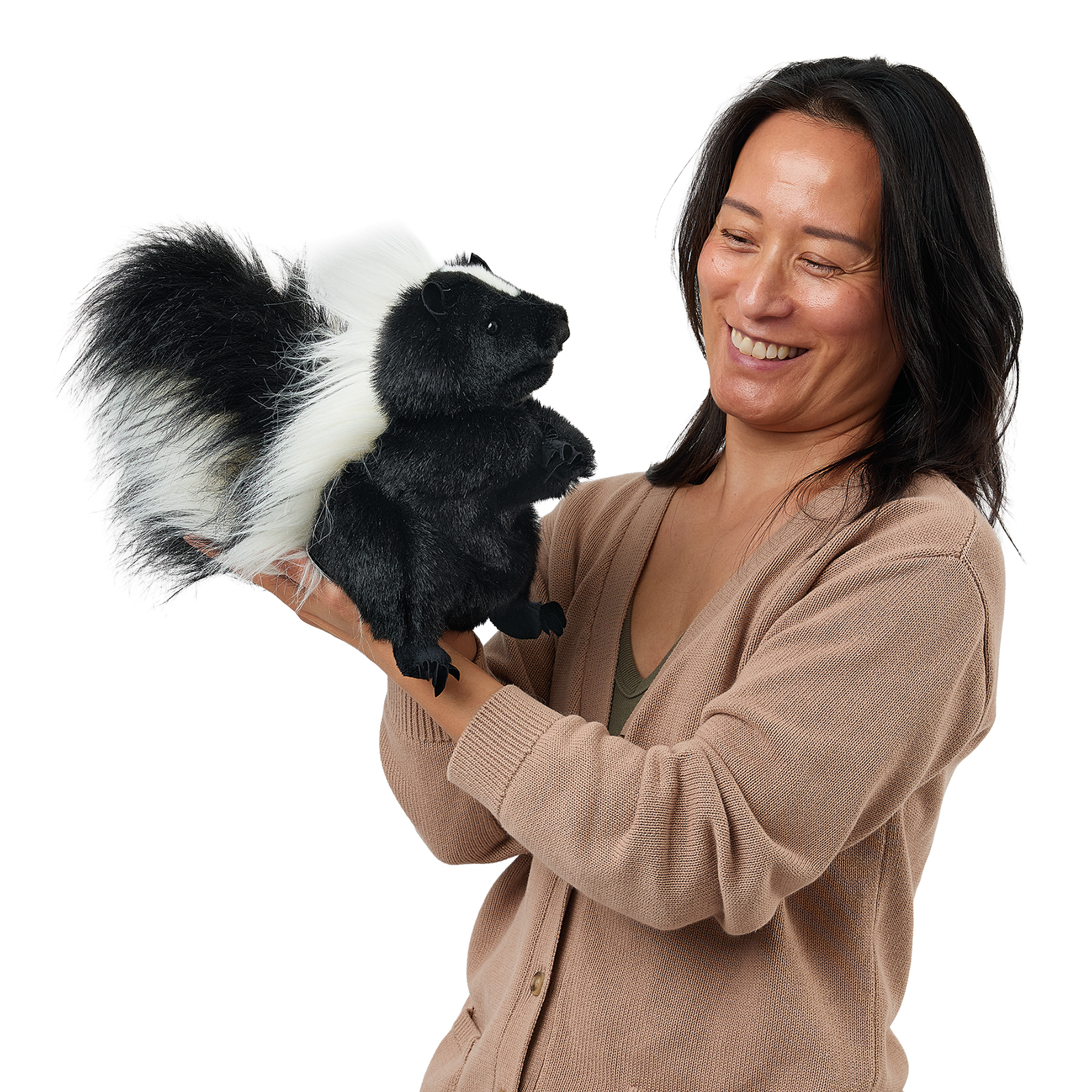 Folkmanis standing skunk hand puppet held by a woman, a front view with a calm pose.