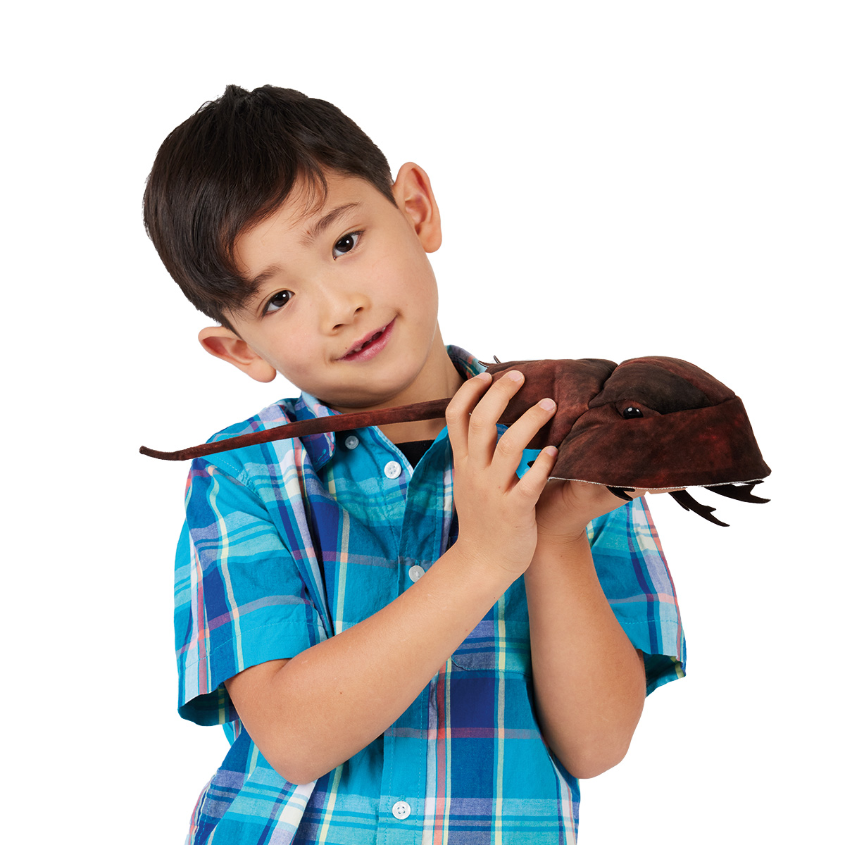 Boy holding the Folkmanis horseshoe crab hand puppet in dark brown with a long tail and legs against a white background