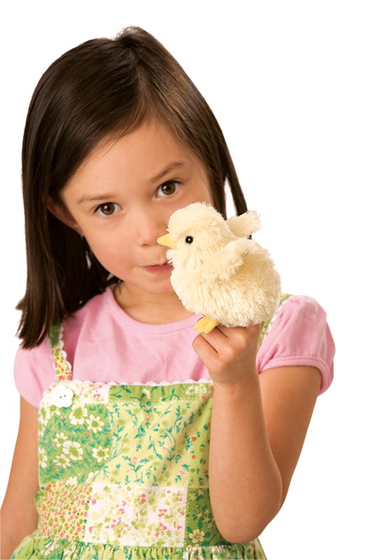 Girl holding a Folkmanis mini chick finger puppet in cream white with a yellow beak close to her face