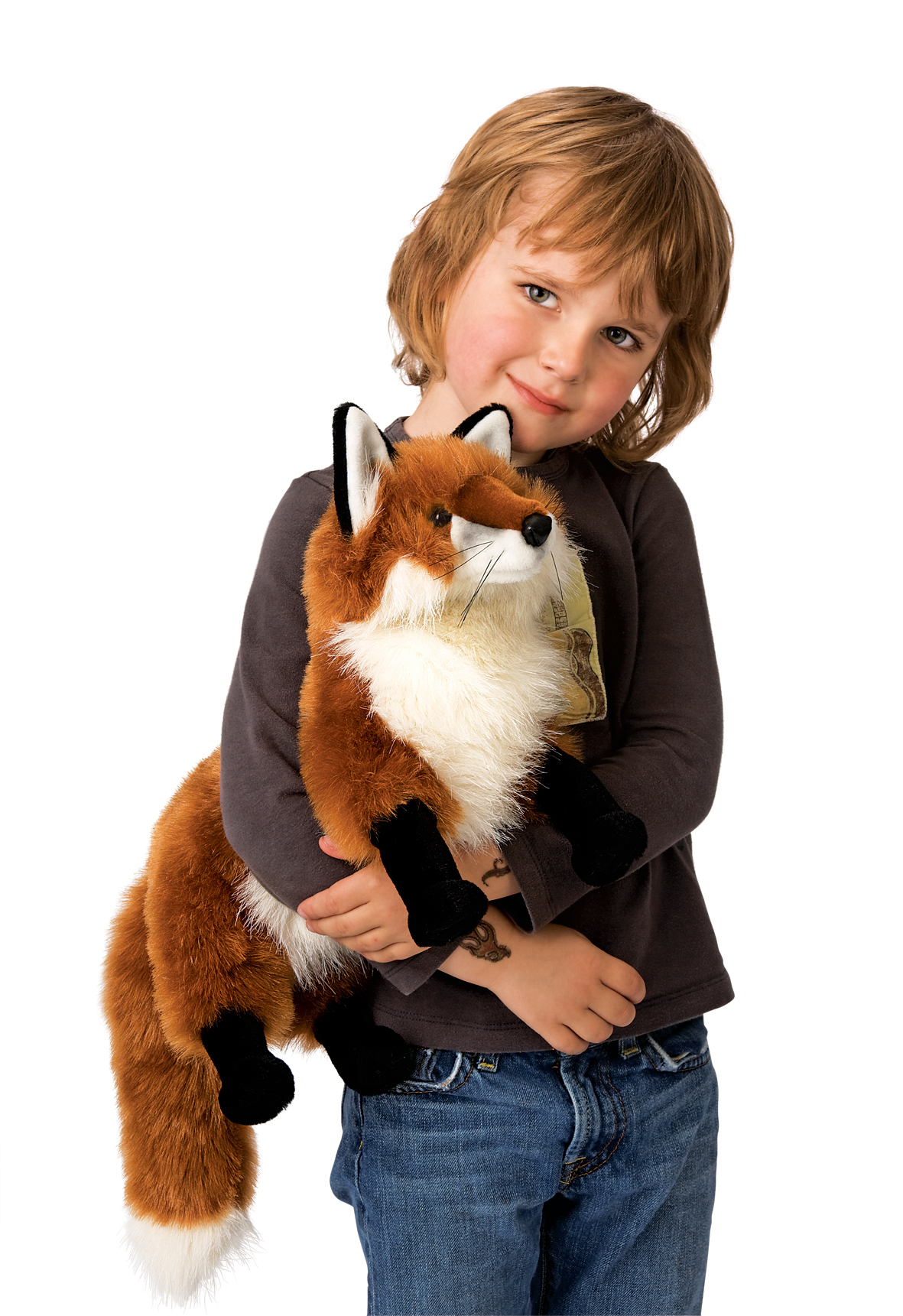 Child holding a large Folkmanis red fox hand puppet with reddish-brown fur, white chest and bushy tail in their arms