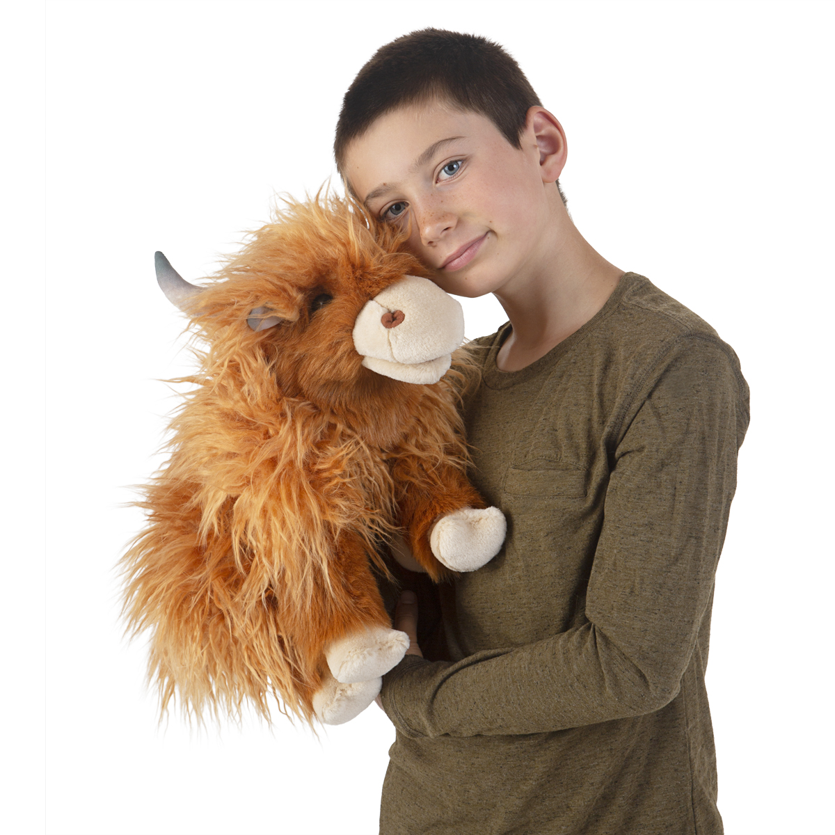 Boy holding the Folkmanis Scottish Highland cow hand puppet with shaggy rust-brown fur and curved horns in his arms