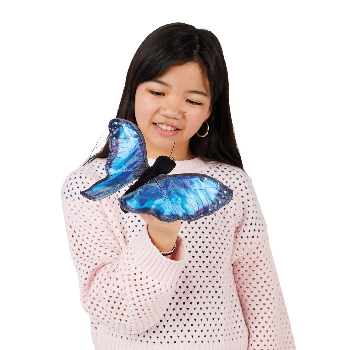 Girl holding a Folkmanis blue morpho butterfly hand puppet with vivid blue fabric wings on her hand