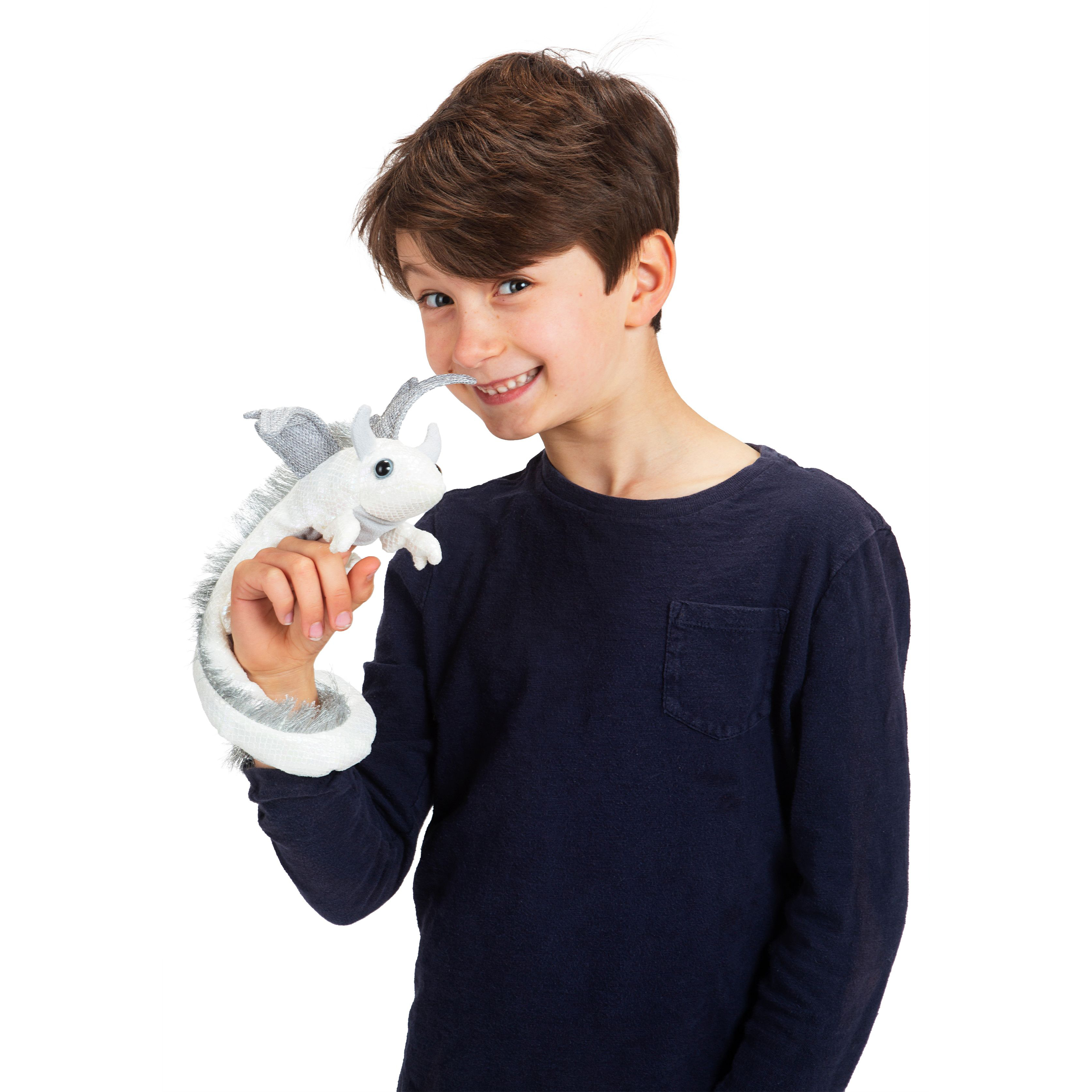 Boy holding a Folkmanis white and silver dragon wristlet finger puppet on his hand, with the dragon looking up at his face