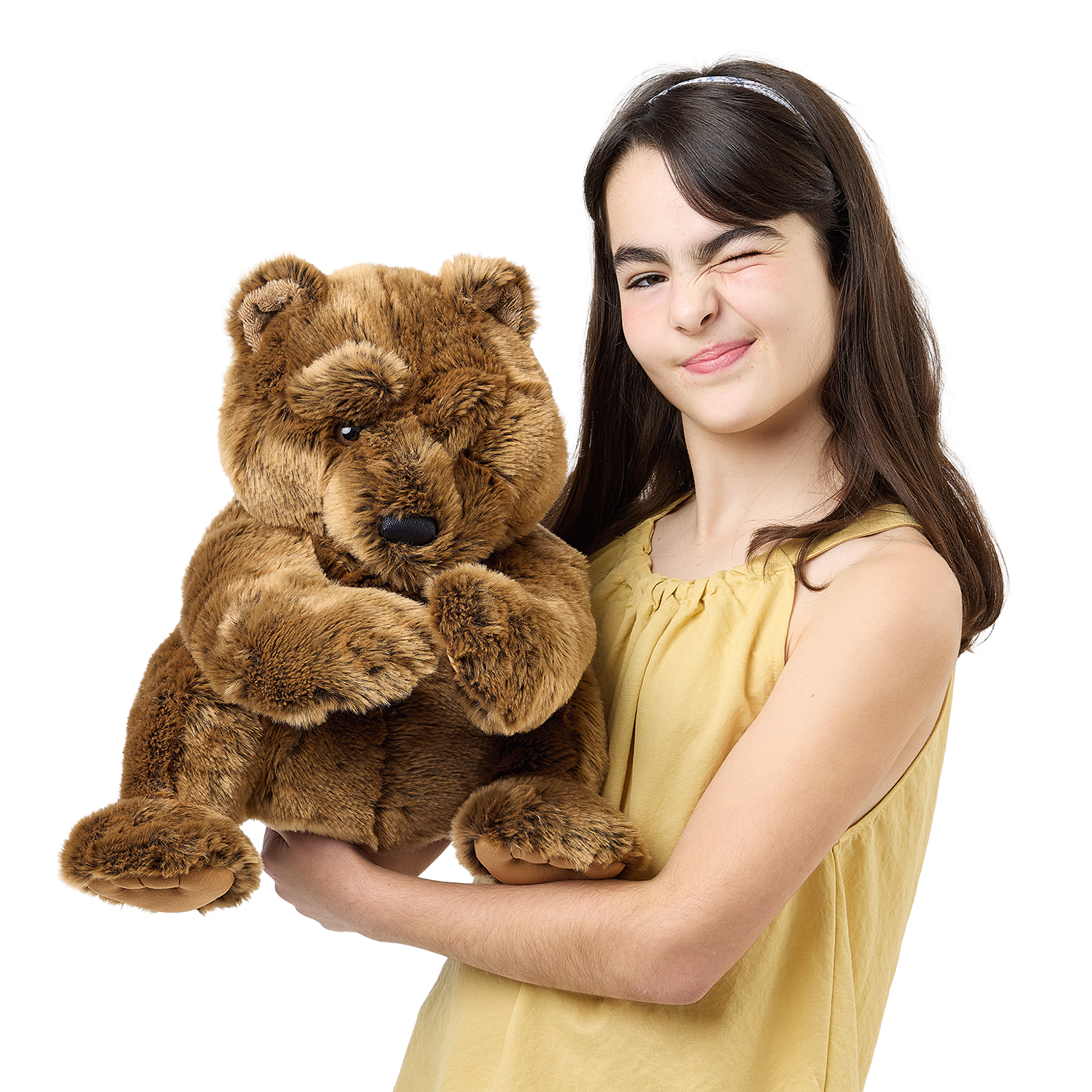 Folkmanis large bear hand puppet held by a girl, front view with its mouth closed and a calm pose.