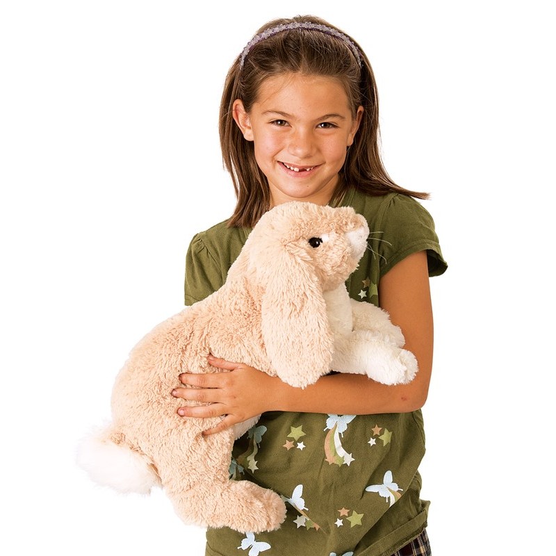 Girl holding the Folkmanis floppy bunny hand puppet in cream plush with long floppy ears in her arms