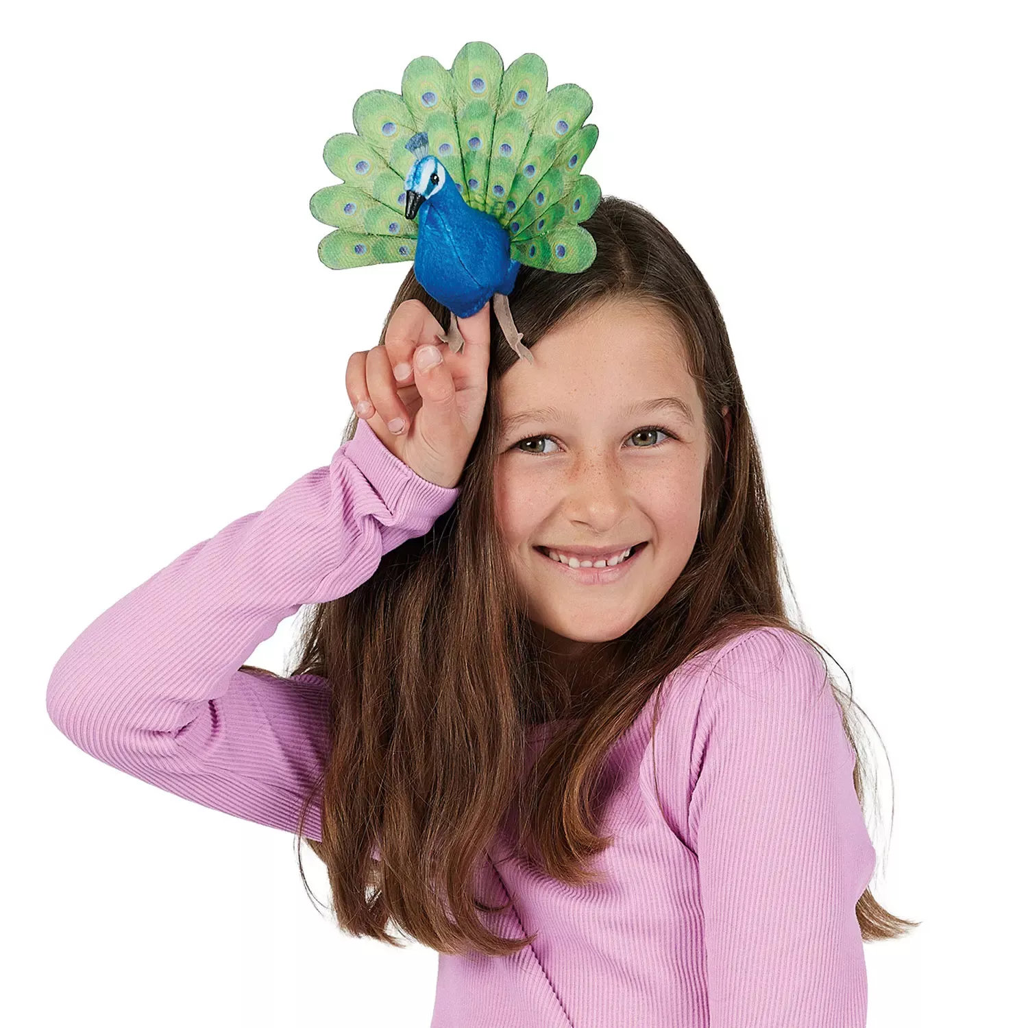 Girl holding a Folkmanis mini peacock finger puppet with a blue body and green tail fan on her index finger above her head