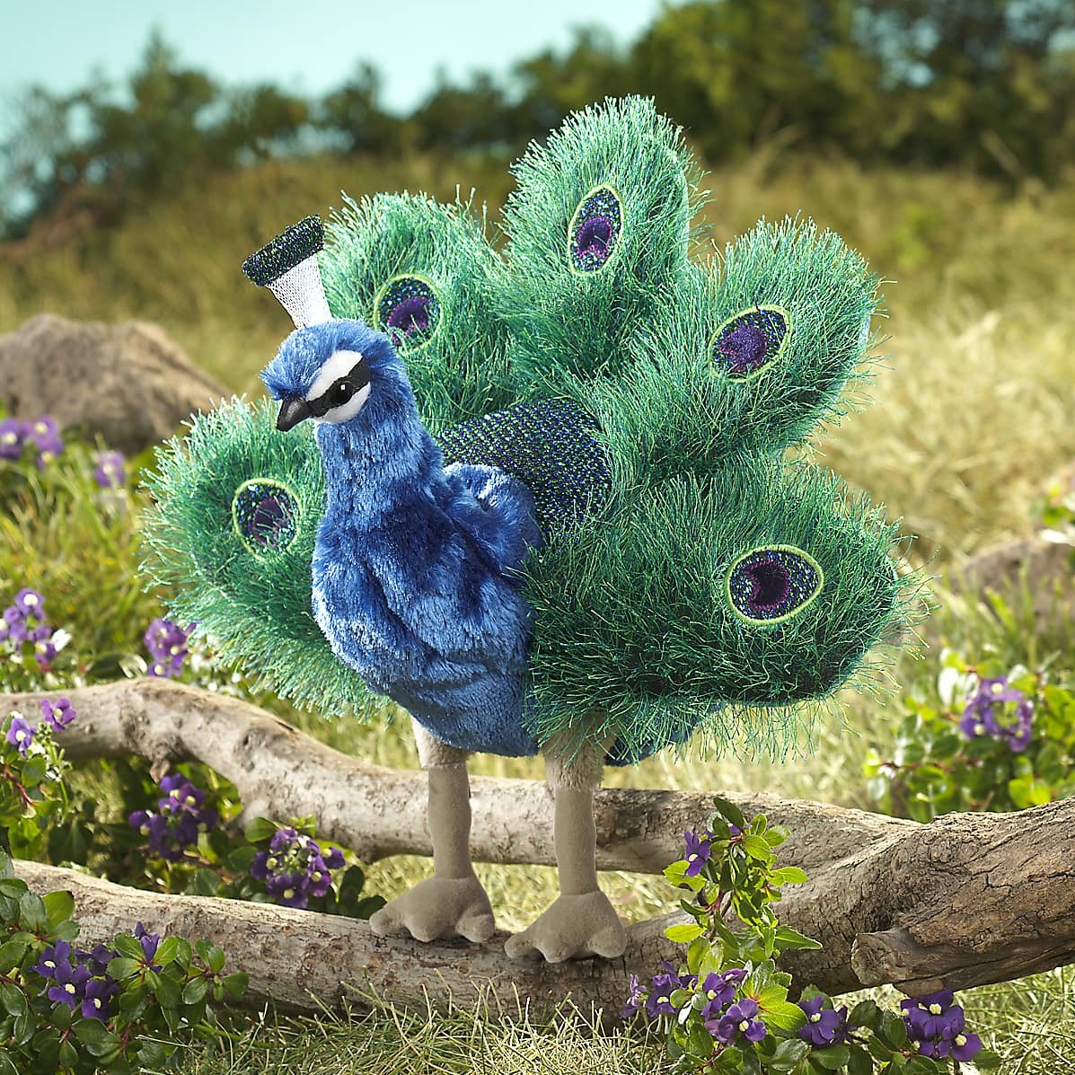 Folkmanis hand puppet small peacock with fanned green-blue tail and purple eye spots, standing on a branch