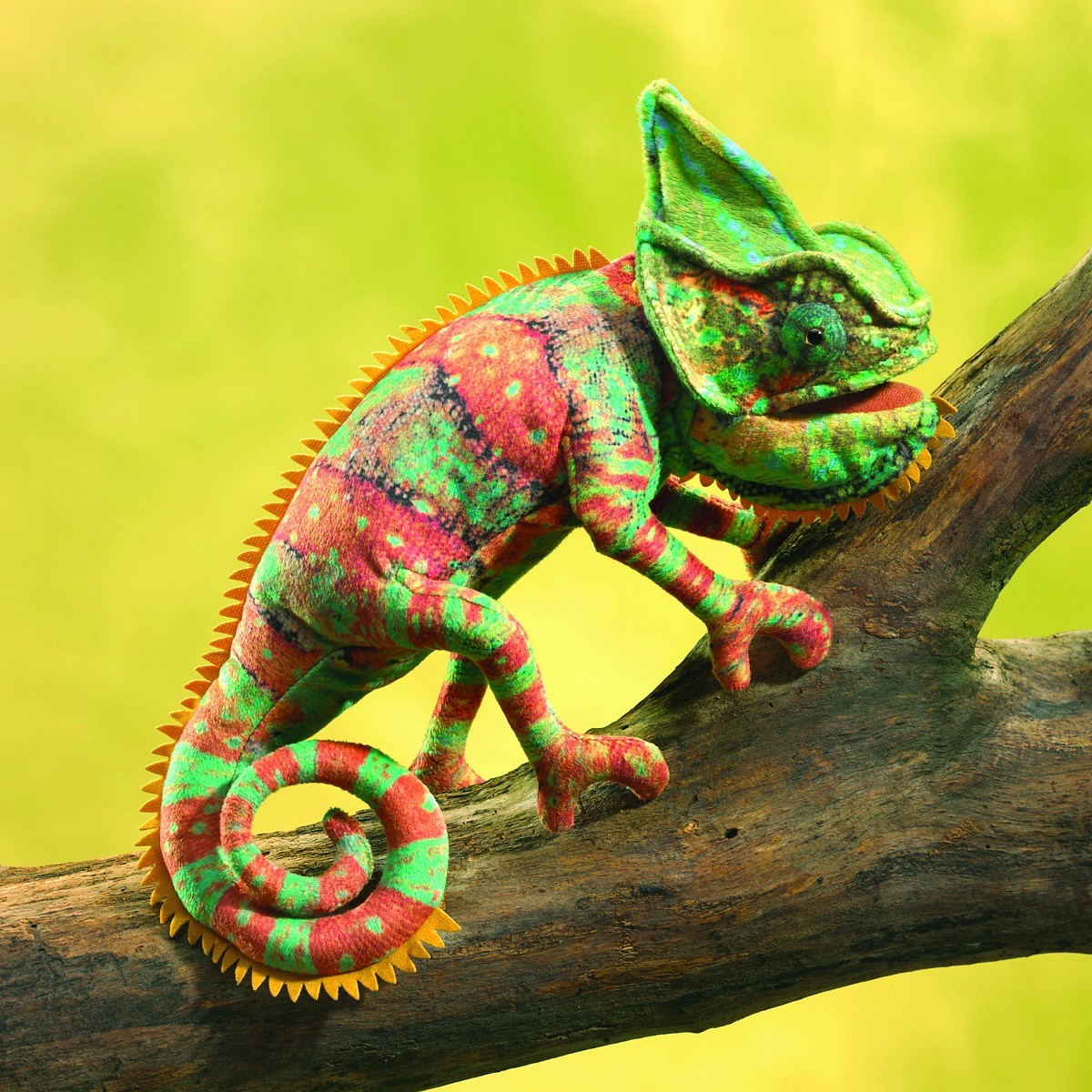 Folkmanis hand puppet small chameleon in red and green with a serrated dorsal crest, positioned on a branch, side view