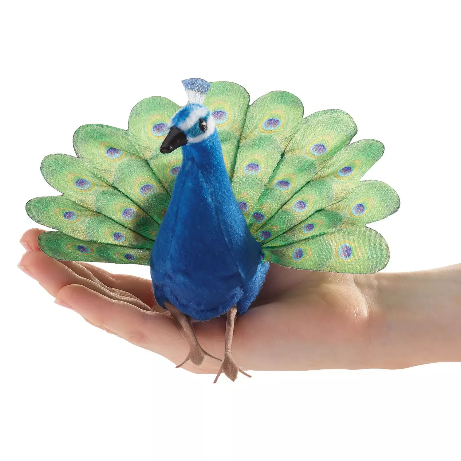 Folkmanis mini peacock finger puppet with a blue plush body and fanned green tail, balanced on a palm