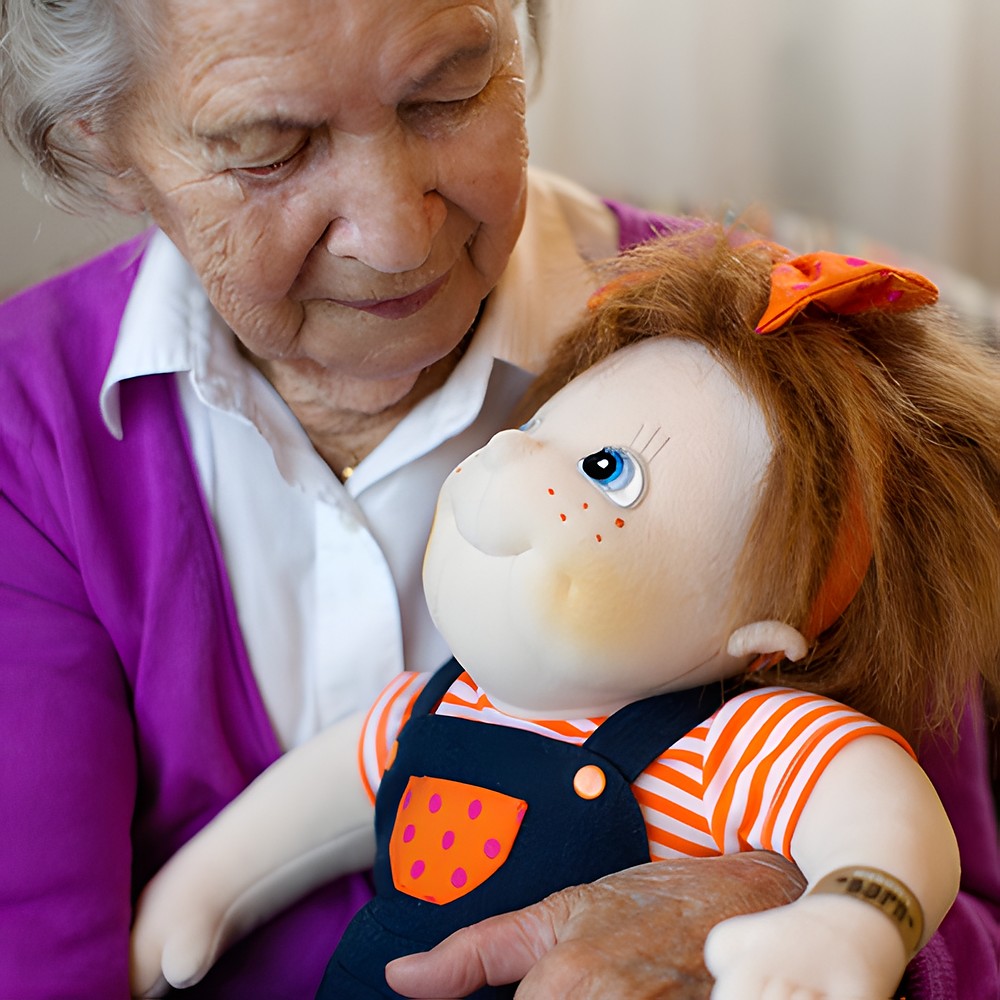 Senior lady holding the Rubens Barn Original doll Anna in her arms