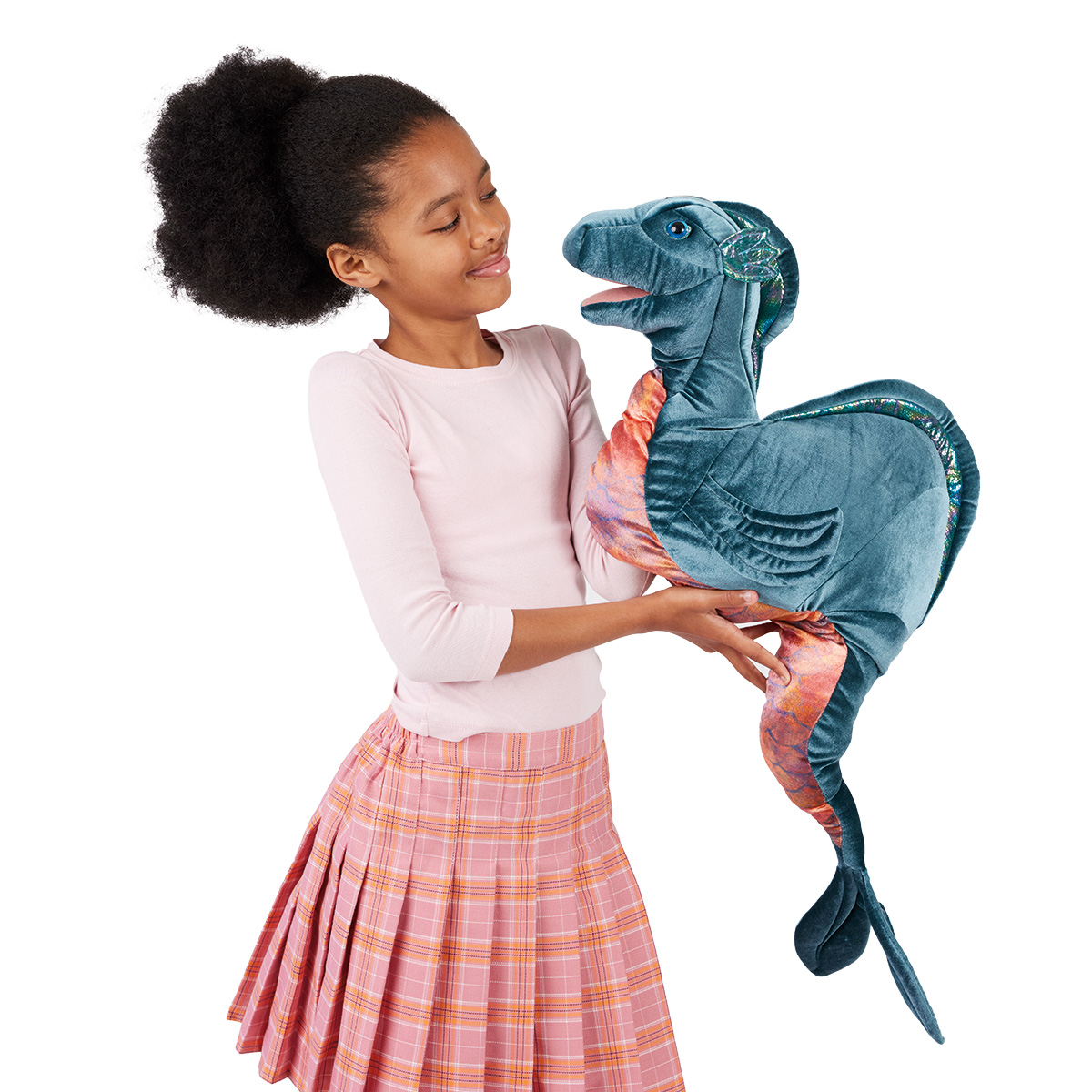 Girl holding up a large Folkmanis Loch Ness Monster hand puppet made of blue velvet with shimmering fins and an open mouth