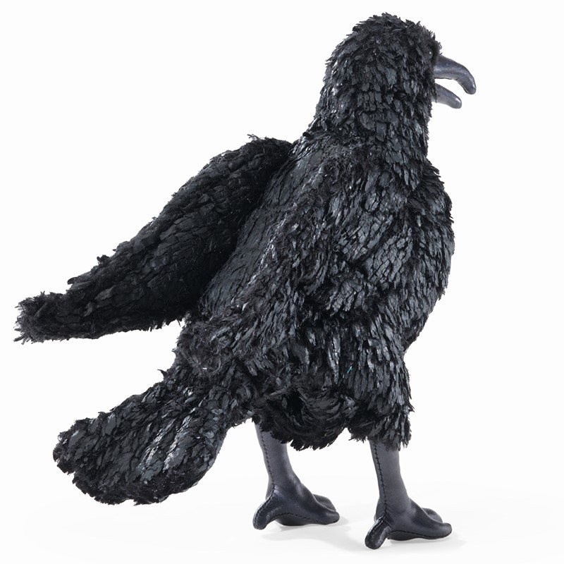 Folkmanis crow hand puppet shown from the side, fully black with textured plumage, open beak and black claws