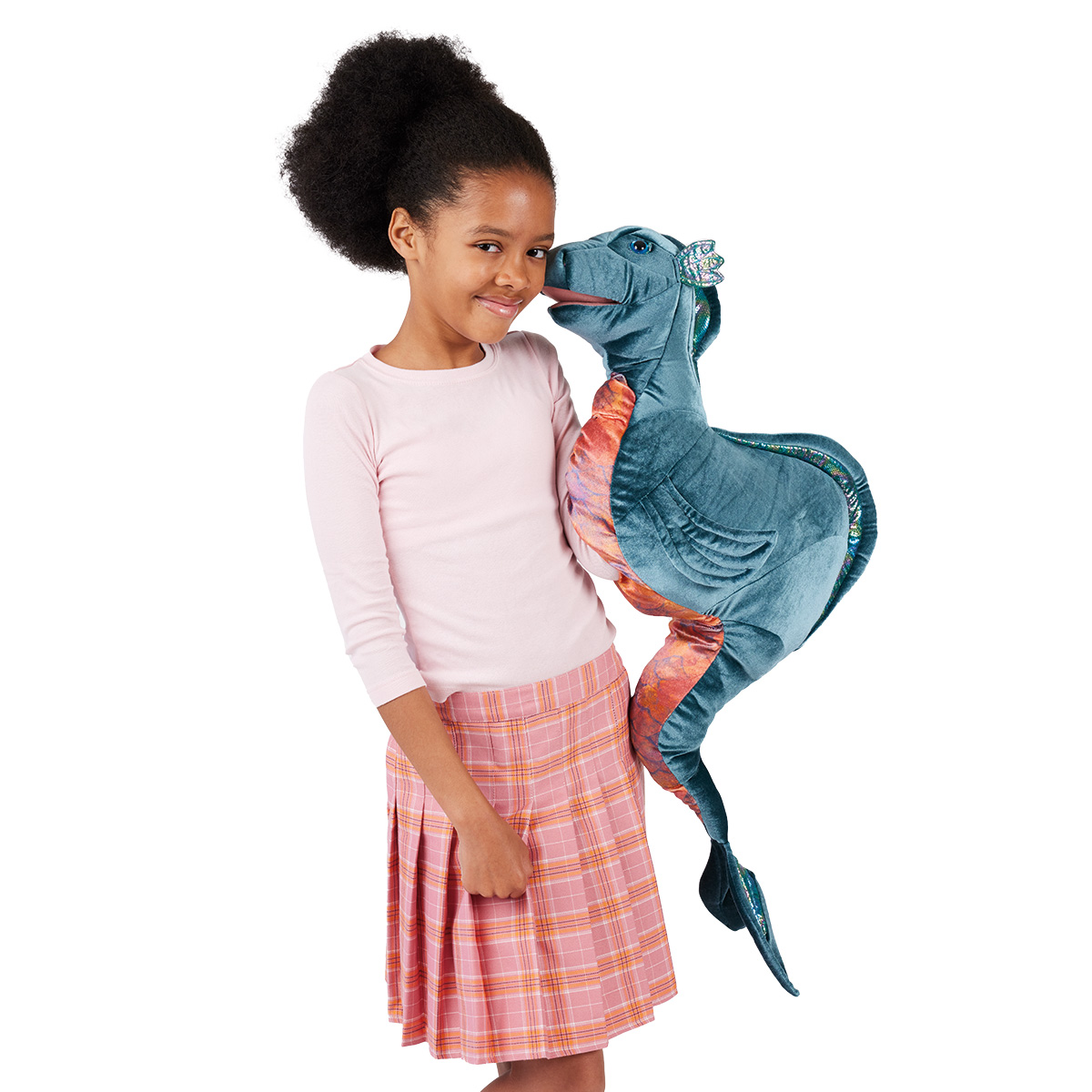 Girl holding a large Folkmanis Loch Ness Monster hand puppet in teal and copper with a glittery crest, touching her face