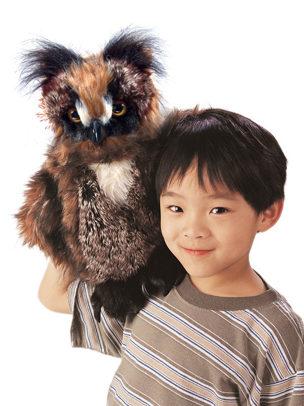 Folkmanis owl hand puppet with brown plumage and yellow eyes, worn on a child's hand