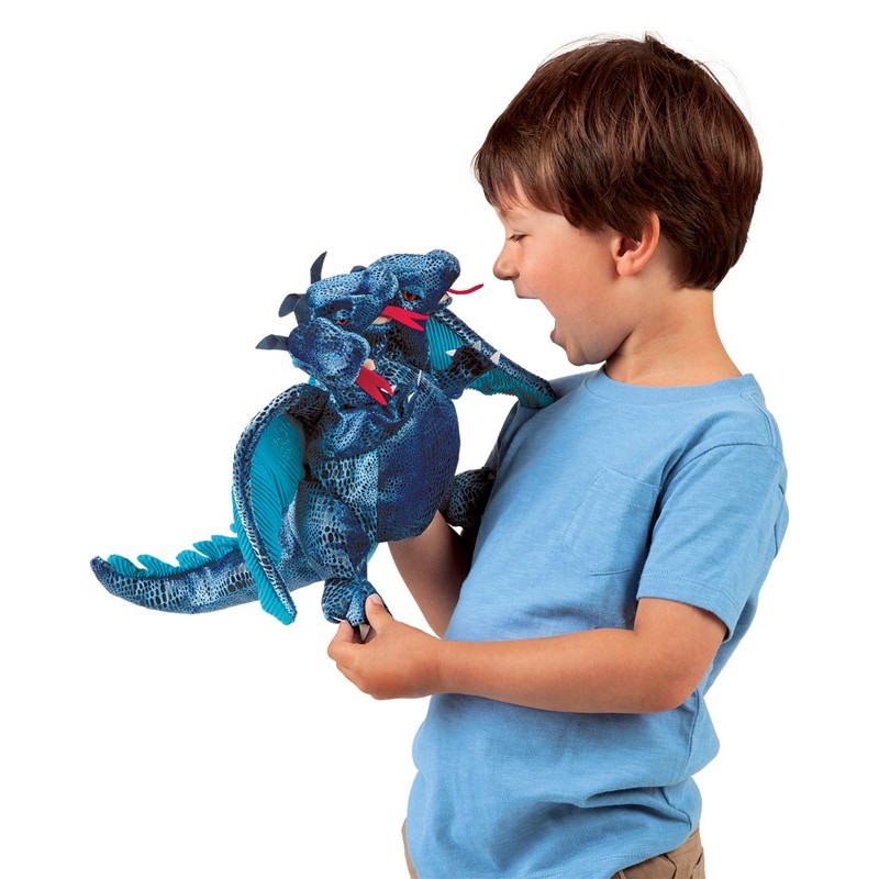 Boy playing with a blue three-headed dragon hand puppet by Folkmanis, side view with open mouths and red tongues