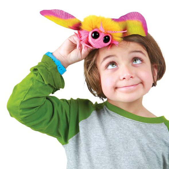 Folkmanis mini Rosy Maple Moth finger puppet in pink and yellow, balanced on a child's head, front view