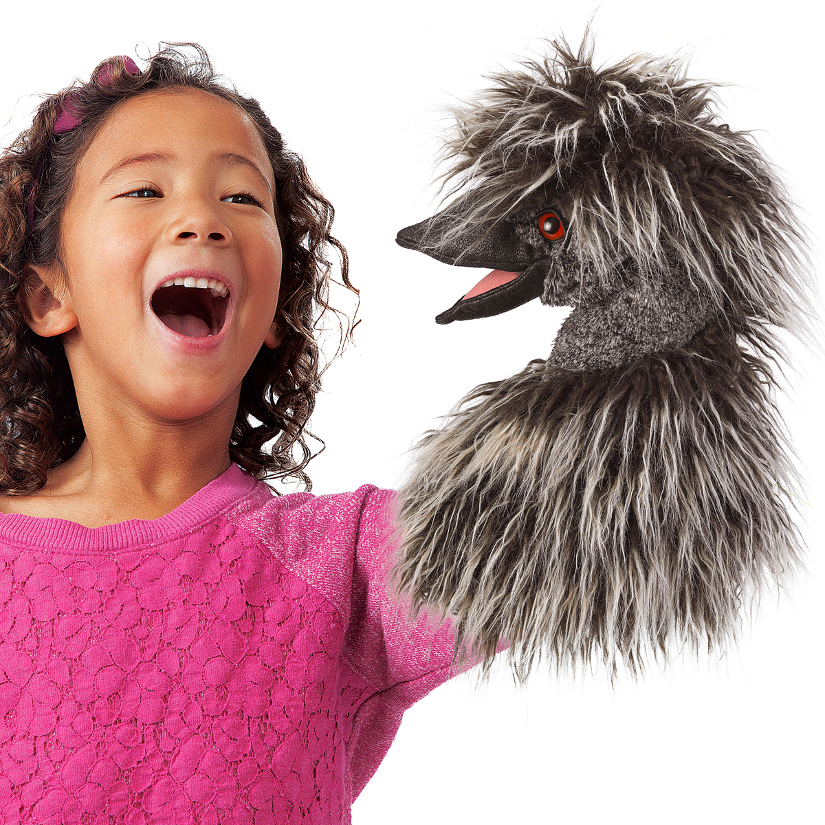 Laughing girl holding a Folkmanis emu hand puppet with shaggy grey feathers and an open beak on her outstretched arm