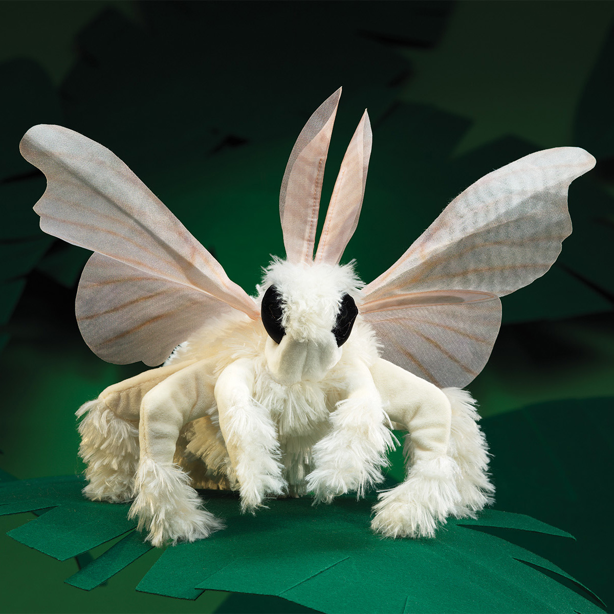Folkmanis hand puppet poodle moth with cream fabric wings, fluffy white body and large black eyes, front view