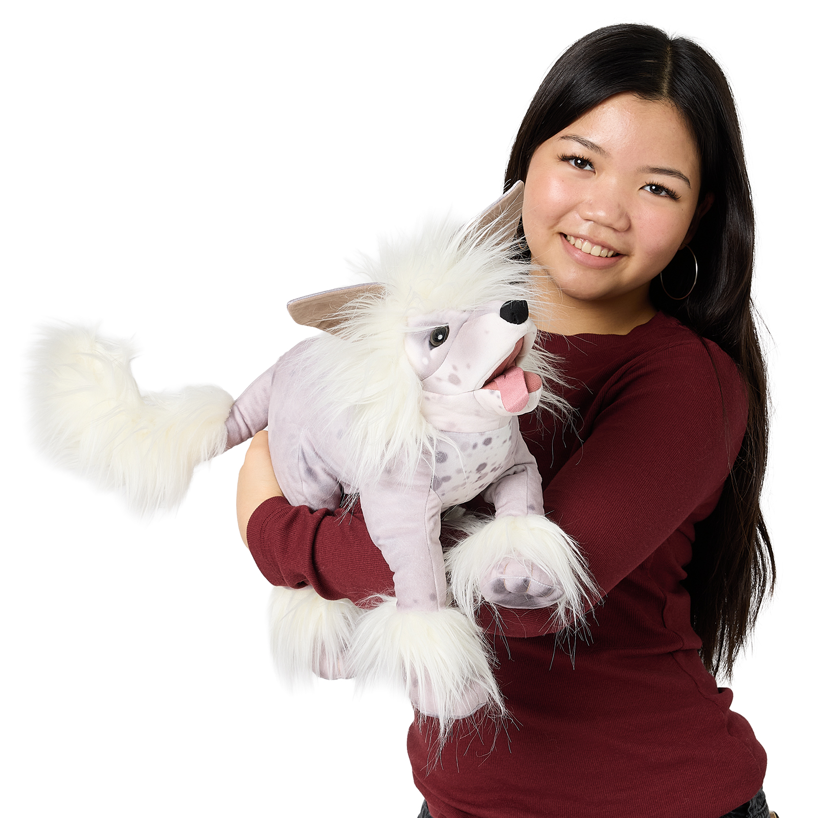 Folkmanis hand puppet Chinese Crested Dog with white fur and a spotted body, worn on the arm of a young woman