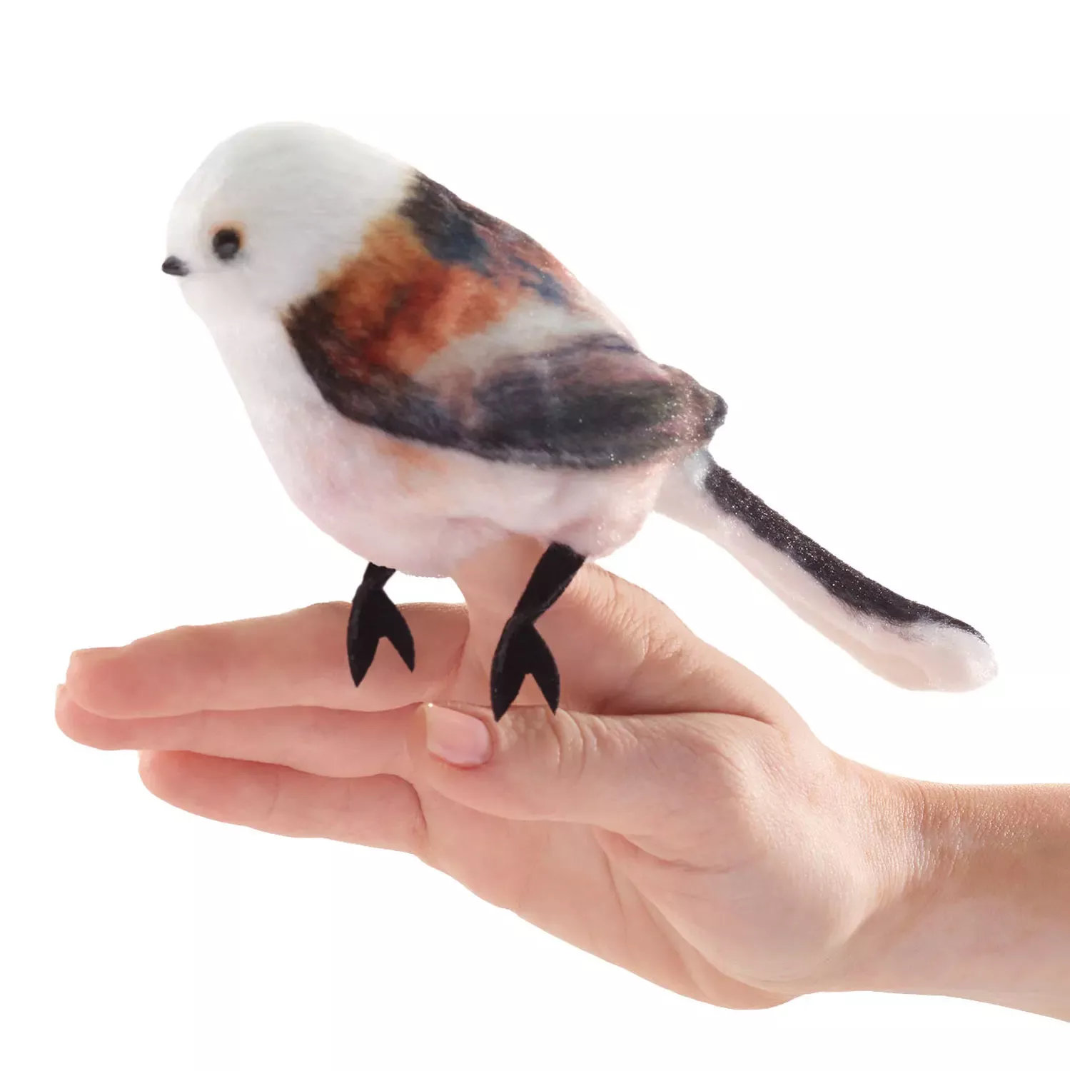 Folkmanis mini long-tailed tit finger puppet with a white head and rust-brown plumage, standing on an open palm