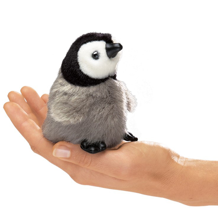 Folkmanis mini baby emperor penguin finger puppet with grey plush belly and black head, sitting on a palm