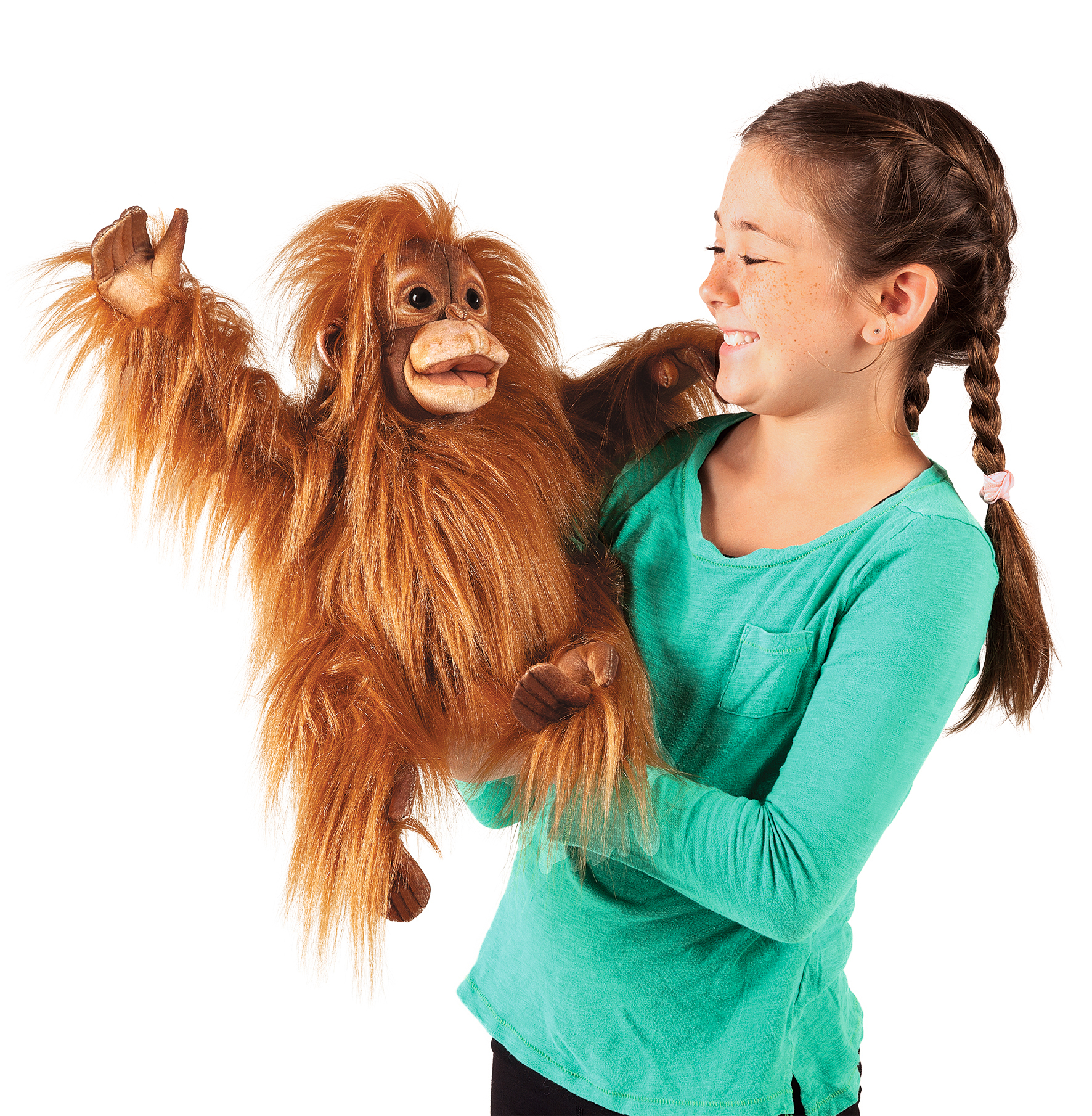 Girl operating the Folkmanis baby orangutan hand puppet with a movable mouth and long reddish-brown plush fur, side view