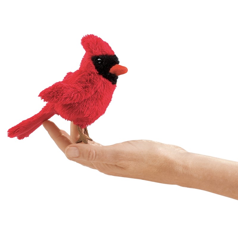 Folkmanis mini cardinal bird finger puppet in vivid red with black face mask, perched on a finger